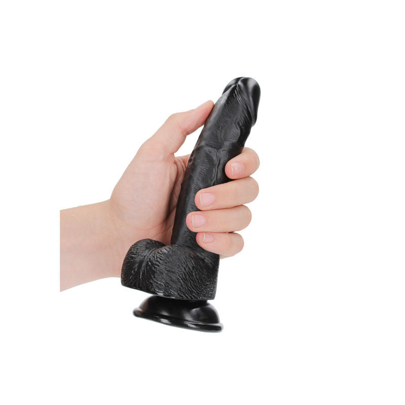 Realrock realistic regular curved dong with balls - 18 cm - Product side view, in a hand  | Flirtybay Adult Shop Australia Lingerie Shop